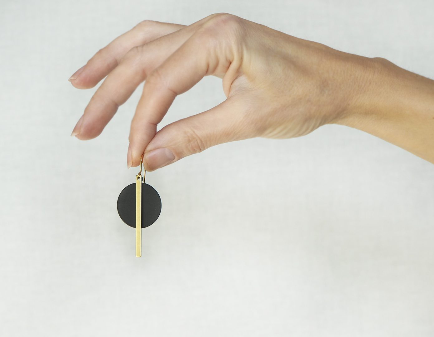 Black disc and brass bar earrings
