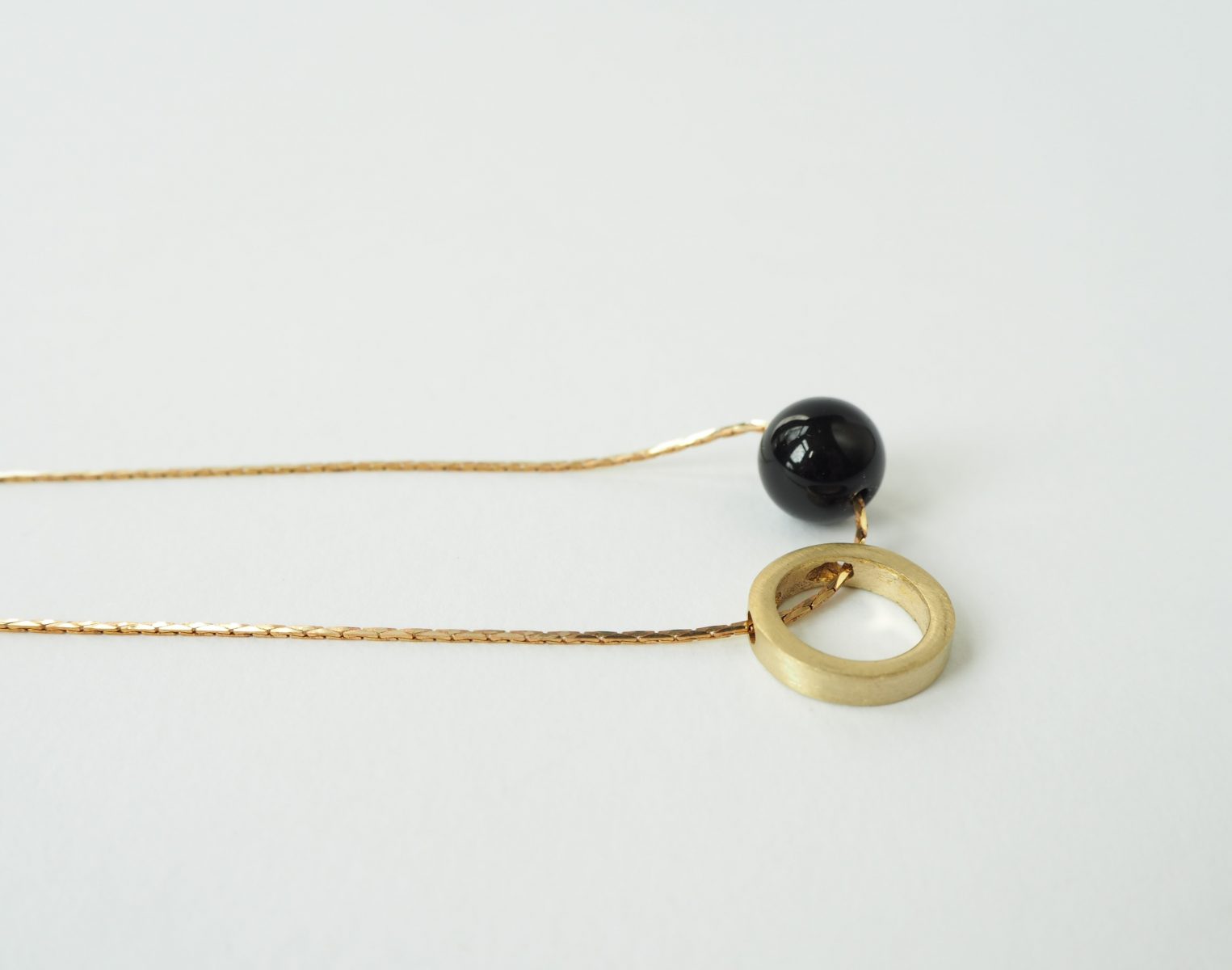 Brass circle and onyx stone necklace