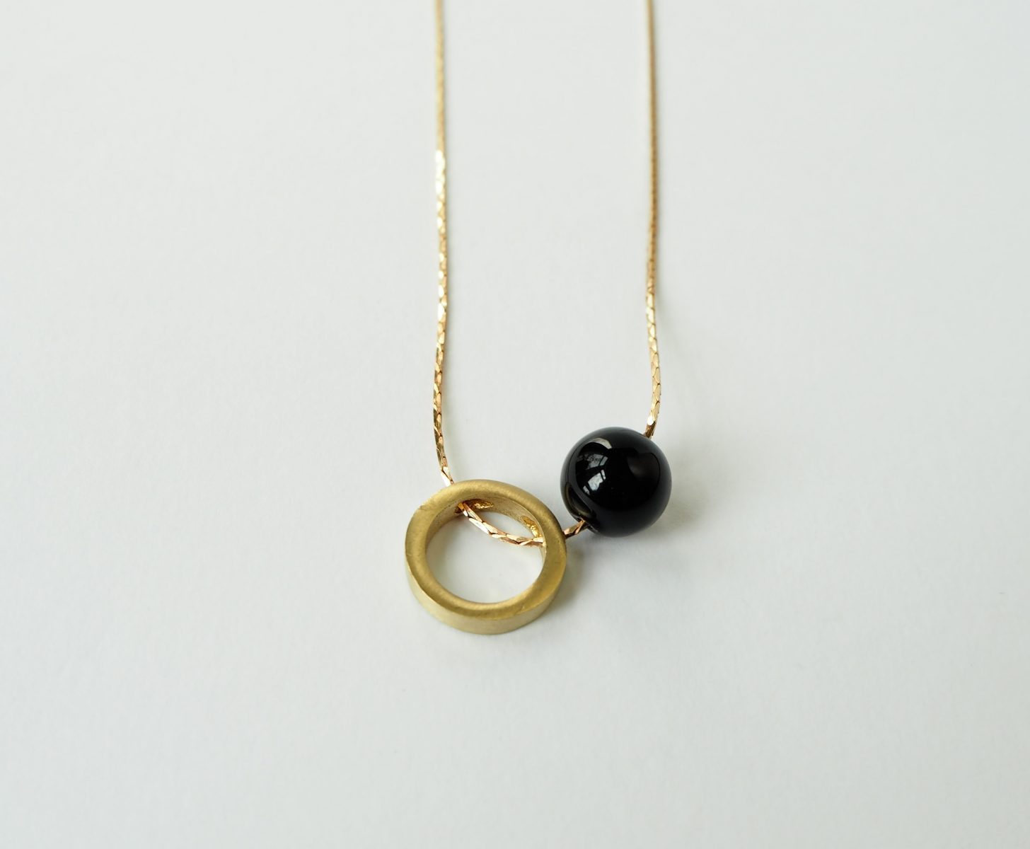 Brass circle and onyx stone necklace