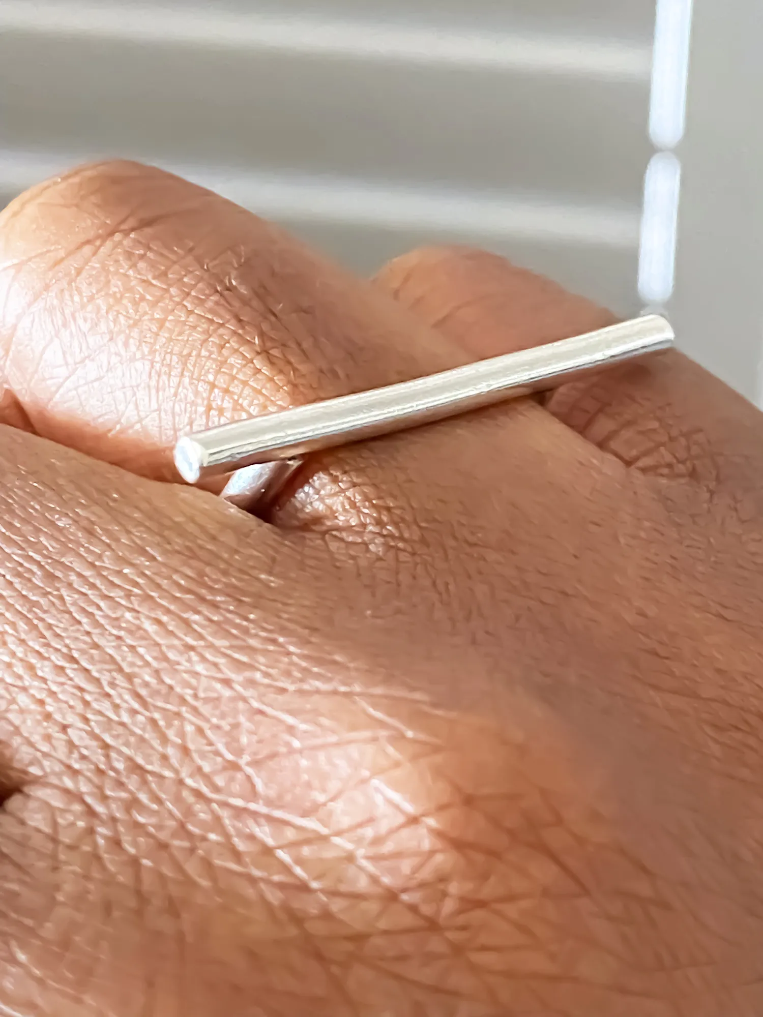 Close-up of the Sculpted Bar Ring on hand, highlighting bar detail.