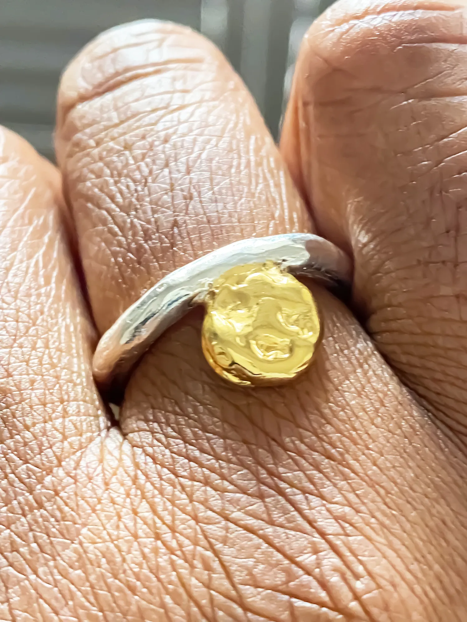 Close-up of the Circle Accent Ring on hand, showing detailed texture