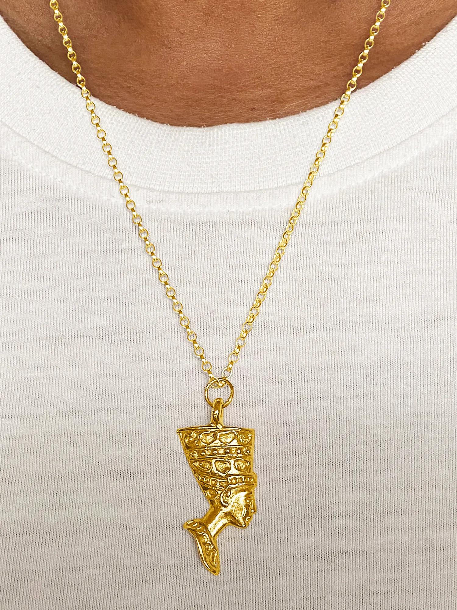 Gold Nefertiti necklace over a white top