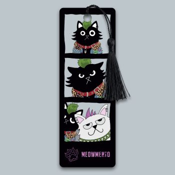 Illustrated bookmark styled as a photo booth strip, showing a green-mohawked black punk cat posing alone in the first two panels, then reacting with displeasure as a white cat with a purple mohawk joins the frame in the final panel. Black background. Black tassel attached. Original artwork by Baldy and the Fidget.
