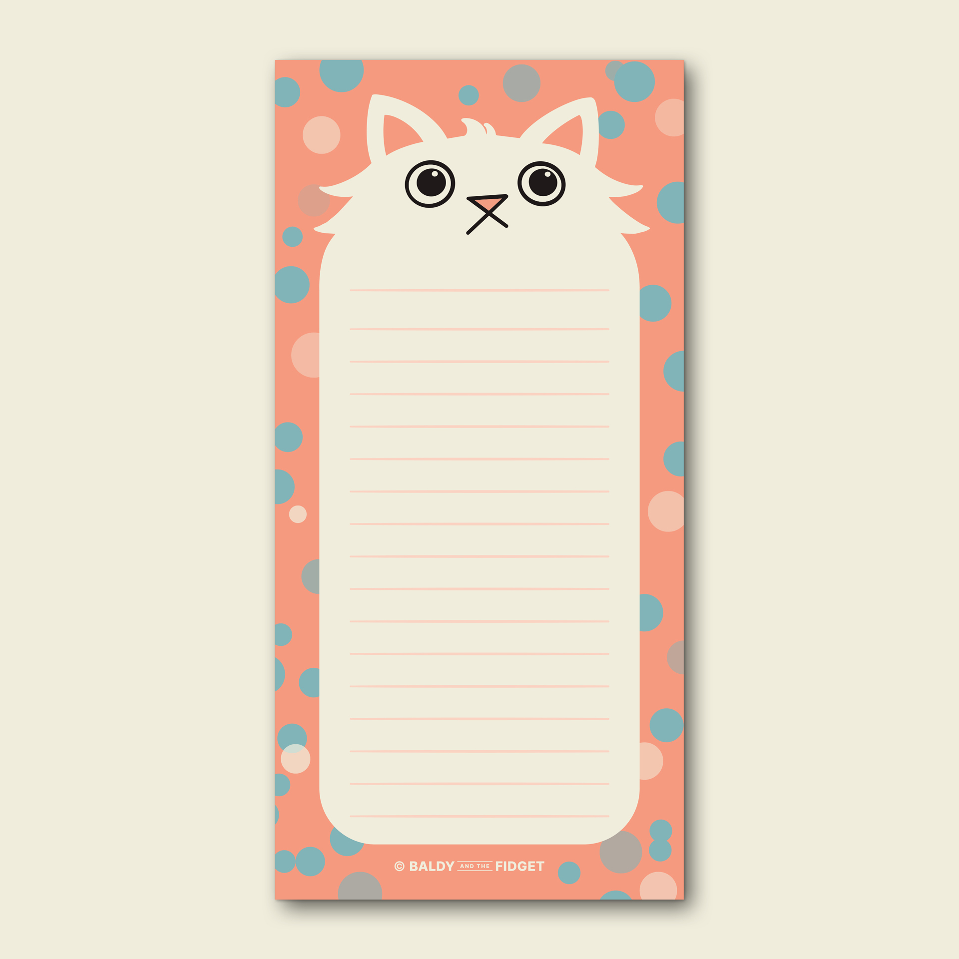 Paws for Thought cat shopping list pad by Baldy and the Fidget, showing a fluffy white cartoon cat illustration on a coral background with teal and pink spots, displayed with a branded belly band on a wooden surface alongside a pen and succulent plant.