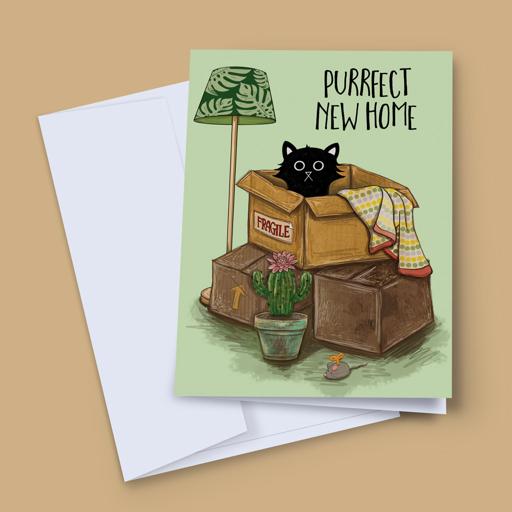 Purrfect New Home greeting card by Baldy and the Fidget, showing a black cat sitting in a fragile-labelled moving box surrounded by packing boxes, a floor lamp, cactus and toy mouse on a sage green background, displayed with a white envelope.